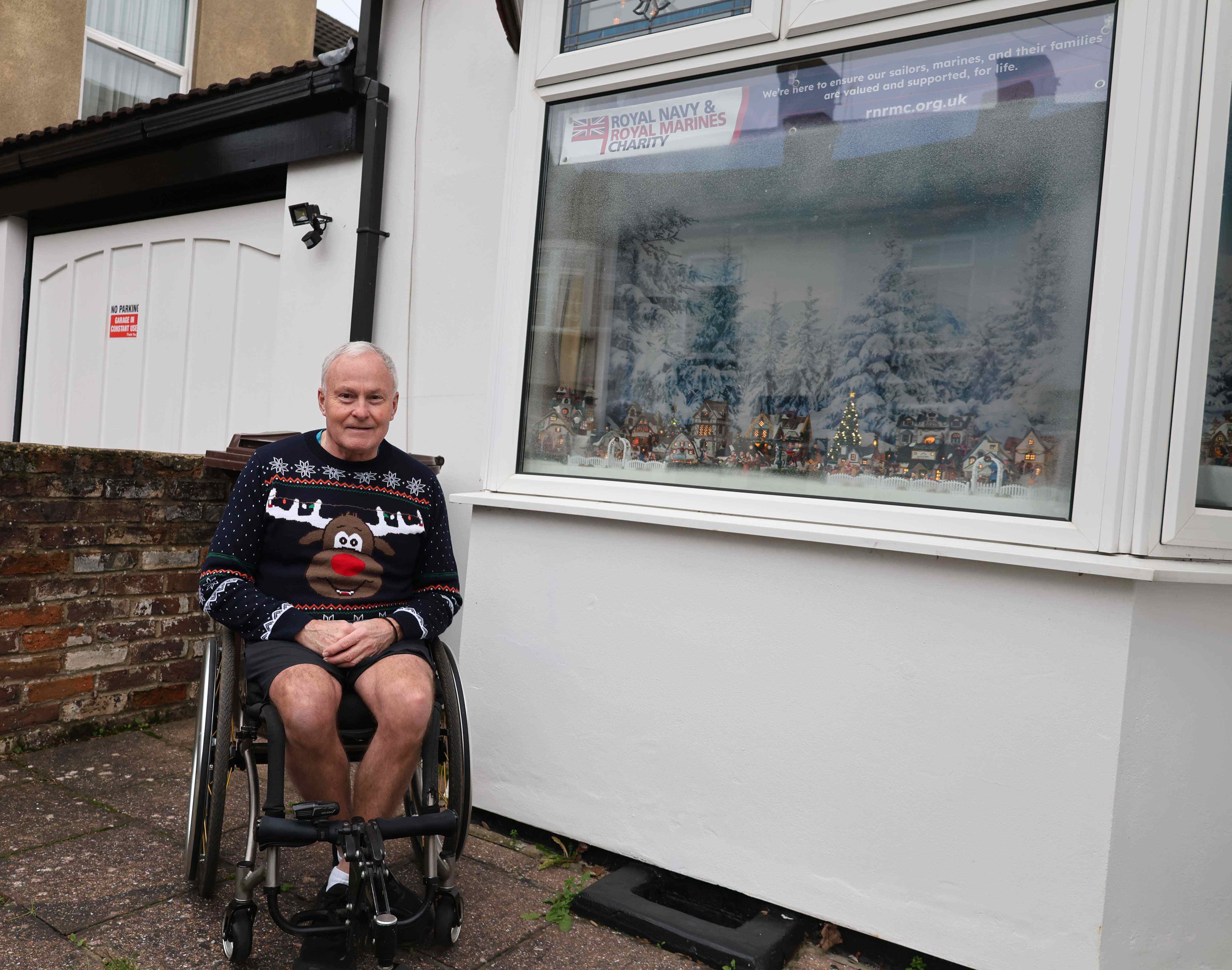 Gentleman sat in a wheelchair outside a window